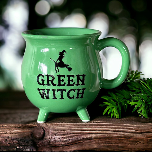 Green cauldron mug with black writing that reads Green Witch