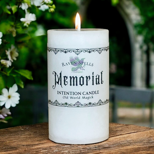 white memorial pillar candle on an altar with flame