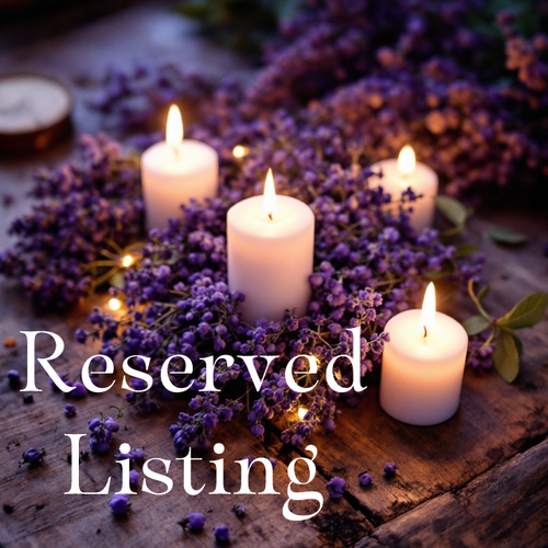 candles on a table with flowers with reserved listing text