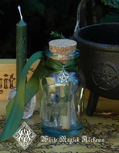 corked glass money drawing jar spell kit with ritual oil resin and green candle for attracting wealth and financial blessings