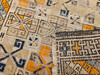 Antique 19th-century Caucasian Kazak bagface with geometric squares in blue, brown, and red. Small tribal rug for wall display or textile collection.