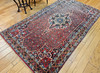 Vintage Persian Bidjar (Bijar) gallery rug with rust red Herati field, navy border, and floral medallion design, early 20th century hand woven carpet.