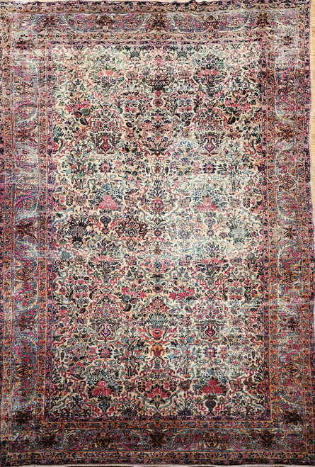 Early 20th Century Vintage Persian Kerman Lavar area rug. Hand-woven. All-over floral vase pattern. Navy blue field. Flowers in turquoise, yellow, green, red, and pink. From the village of Lavar, near Kerman, Persia.