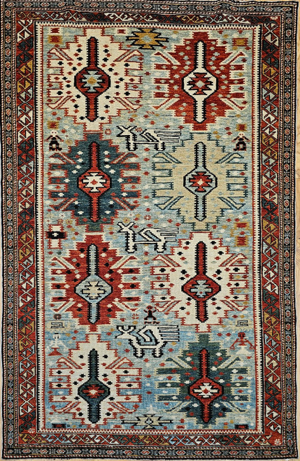 Early 20th-century Caucasian Shirvan-design area rug with ivory field and all-over geometric pattern in pale green and red tones, The Persian Knot Gallery, SKU: 2320