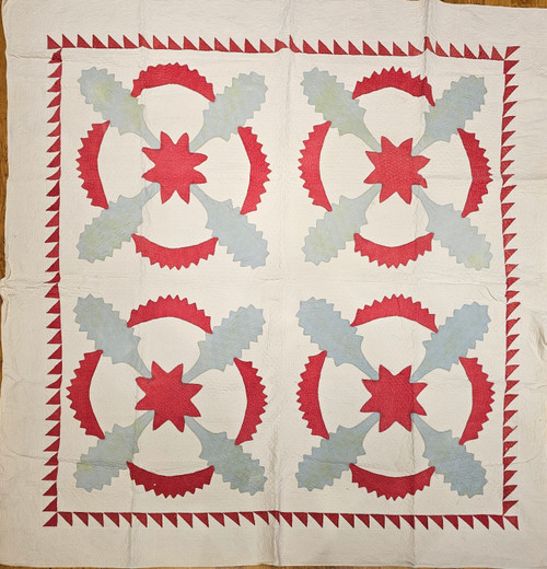 19th century Pennsylvania Dutch hand-stitched appliqué quilt with floral motifs, pale blue and red circular designs, ivory background, and sawtooth border, displayed as antique textile wall art, The Persian Knot Gallery, SKU: 2353