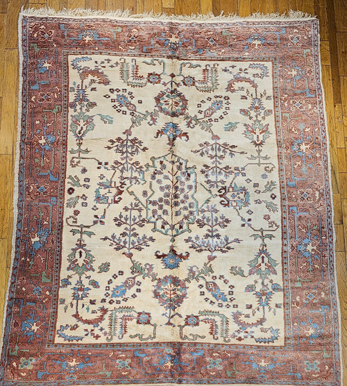 Mid-20th Century Vintage Turkish Oushak area rug. Hand-knotted. All-over geometric design. Ivory color background. Scattered larger branches and leaves. Colors in field: turquoise blue, green, brown. Light chocolate brown border with designs in turquoise blue, green, cream. Full pile, wonderful condition.