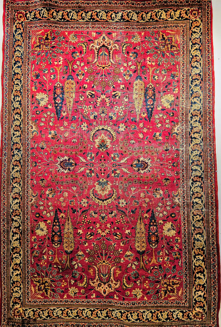 Vintage Persian Kerman Lavar in "Tree of Life" pattern with floral design set in an ivory color field from the first half of the 20th century.  There are several beautiful designs that are incorporated in this rug including a row of cypress trees on the lower part of the rug.  Also the range of the colors in the design include green, gold, blue, and red.  The corner spandrels on the upper section of the design are in a bright red color with floral design.  The primary border is also in ivory color with flowers and tree designs throughout.
