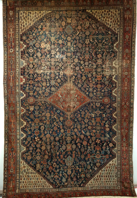 Late 19th-century Persian Qashqai tribal gallery rug in navy, ivory, and royal blue with paisley motifs and central medallion.