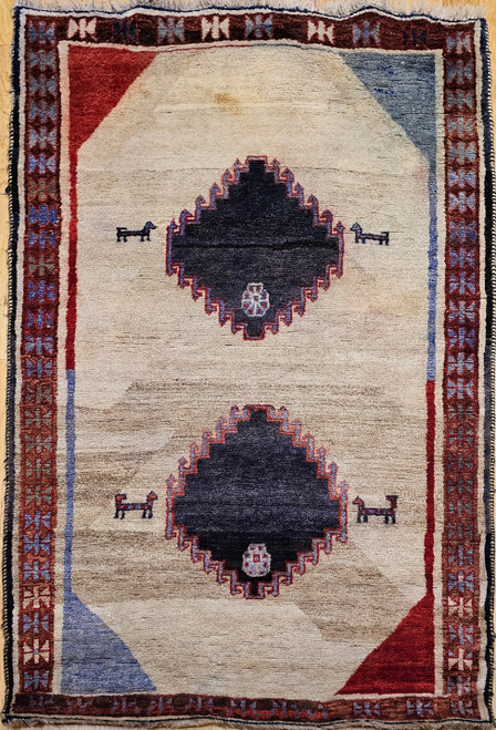 Vintage Persian Gabbeh rug in ivory with minimalist tribal diamond design and animal motifs