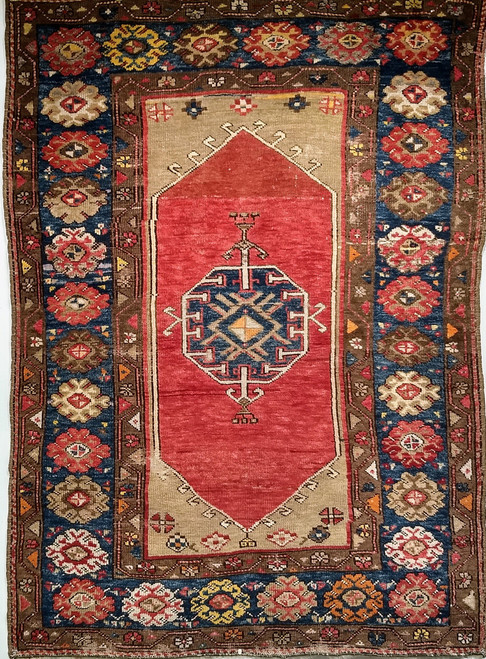 Late 1800s Turkish Anatolian rug with navy blue medallion, red background, tan field, and dark blue geometric border, The Persian Knot Gallery, SKU: 1591