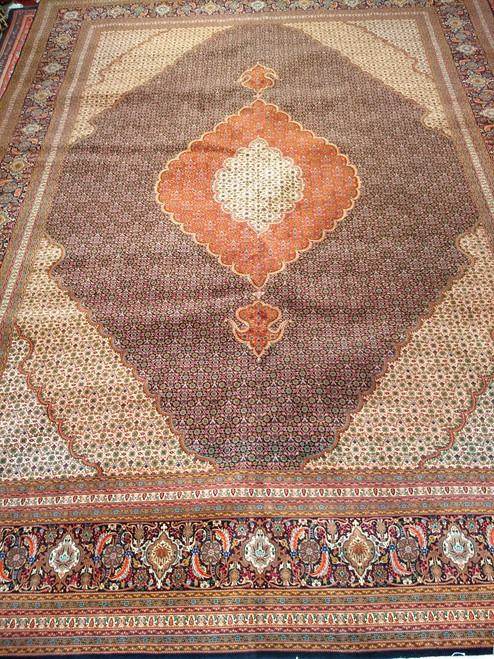 Mid-20th Century Vintage Persian Tabriz Mahi rug. Hand-knotted with a fine weave. Dark navy blue field. Rich dark red central medallion. Pale yellow/cream corner spandrels. Dark navy blue border with floral designs in red, green, blue, and brown.