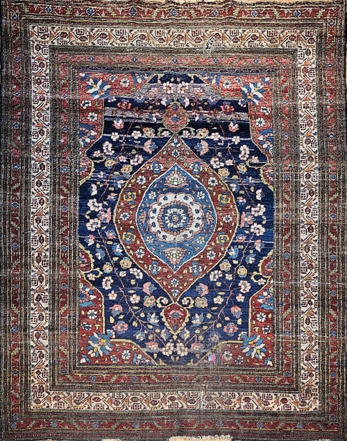 Late 19th Century Antique Persian Kurdish room size rug. Hand-woven. Oversized elongated diamond medallion pattern. Abrash blue color field with streaks of light blue. Medallions in rust, blue, and cream with vines and flowers. Cream-colored main border with geometric design. Colors: navy, French blue, green, yellow, red.