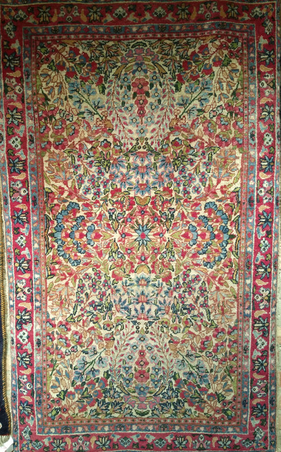 Late 19th Century Antique Persian Kerman Lavar area rug. Hand-knotted. All-over floral pattern on ivory background. Brilliant colors: blue, green, yellow, red, pink. From Kerman village, Persia.