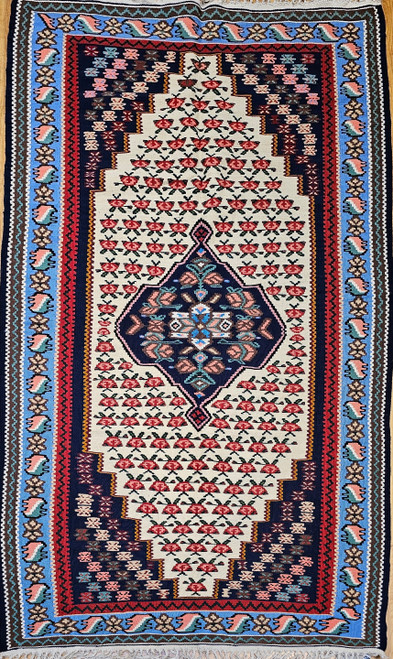 Mid-20th Century Vintage Persian Senneh (Bidjar) Kilim area rug with a central geometric medallion in dark blue, red, cream, yellow on a white field with small flower motifs. Light blue border., The Persian Knot Gallery, SKU 1458