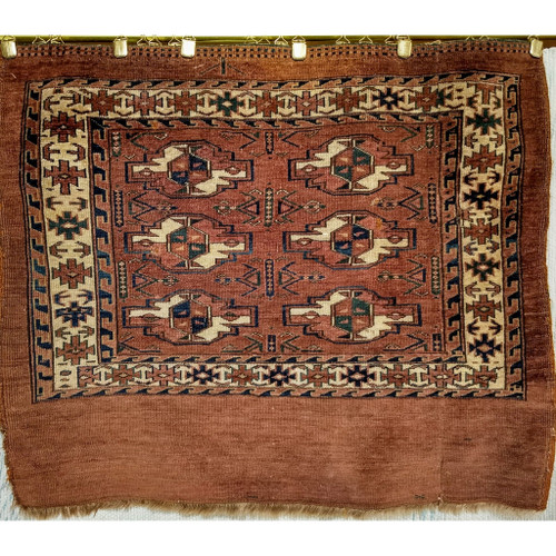 19th-century Turkmen Yomut Chuval bagface with finely woven tribal design and blue-green medallions on a rich wool field