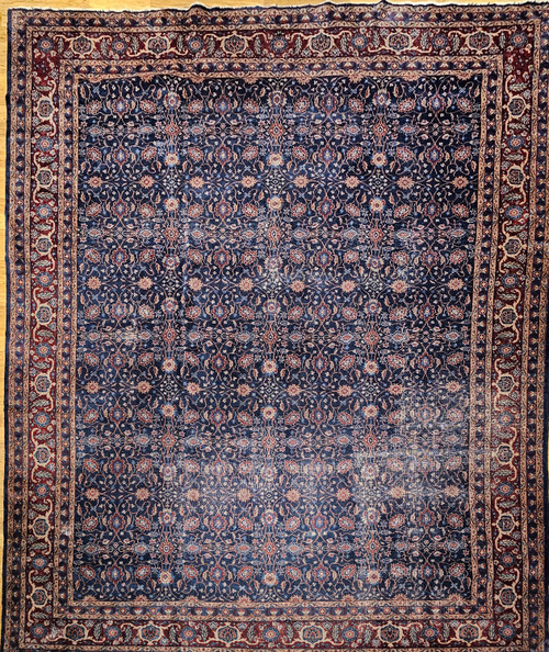 Early 20th Century Vintage Oversize Persian Mahal Sultanabad carpet. Hand-woven. All-over pattern with small medallions and flower heads alternating in columns, connected by curved branches and leaves. Dark navy blue primary field. Dark burgundy border.