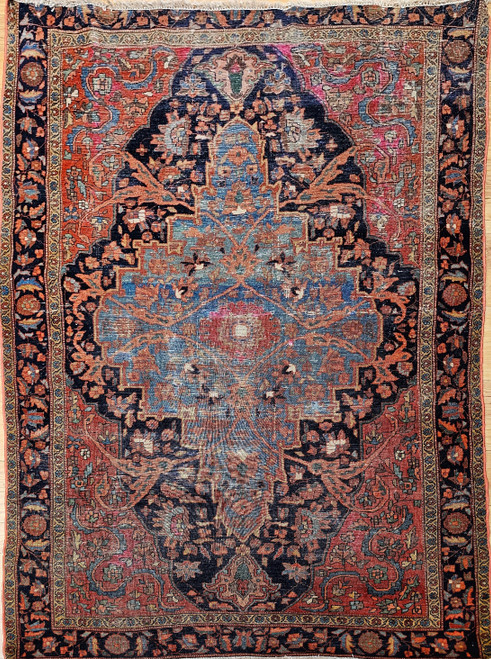 Vintage Persian Farahan rug with pale blue medallion, navy field, red spandrels, and Herati border
