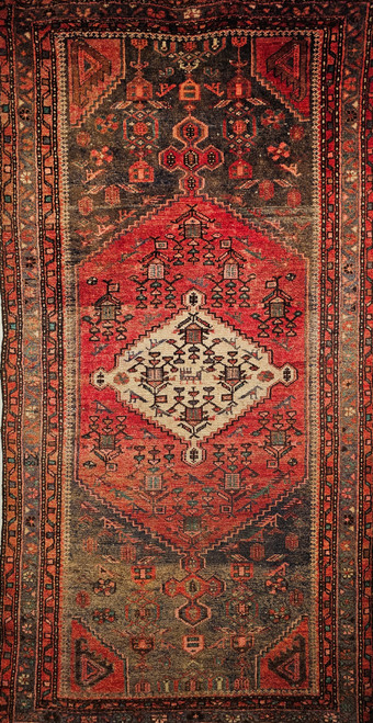 Vintage Persian Hamadan rug in medallion pattern with moss green, red, ivory, and turquoise border featuring geometric and animal motifs.