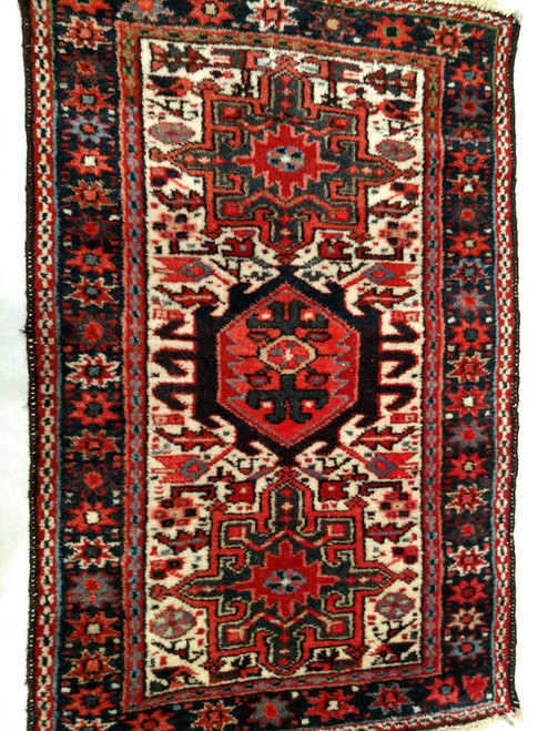 Vintage Persian Heriz Karajeh rug with three medallions in green and red on a cream field, framed by a navy border, hand-knotted circa 1900s.
