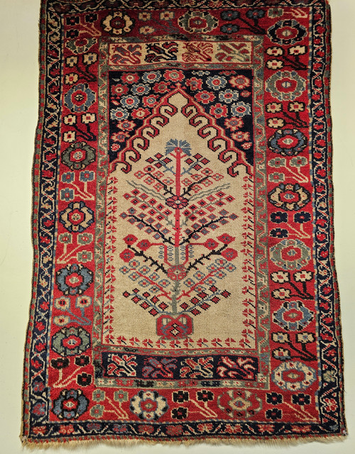 Antique Anatolian Tree of Life prayer rug with ivory field and indigo geometric border, handwoven with natural vegetable-dyed wool, early 1900s, The Persian Knot Gallery, SKU: 1852