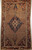 Early 20th Century Vintage Persian Malayer Camelhair area rug. Hand-knotted. Geometric central medallion in navy blue and ivory. Open camelhair background. Rust red corners with geometric designs in blue and yellow. Rust red border.