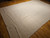 Oversize handwoven natural fiber jute rug in light ivory with braided weave and textured surface, handmade and durable, The Persian Knot Gallery, SKU 2311