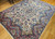 Vintage Persian Kerman Lavar room size  rug in an all-over floral pattern from the early 1900s.  The beautiful Kerman has a floral pattern with flower bouquets in various colors throughout the field in ivory,  red, pink, blue, yellow, and green.  The rug has a wide border with a similar design and color pallet. The profusion of the colors gives one the sensation of walking into a beautiful garden on a nice summer day.