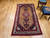 Mid-20th Century Vintage Persian Malayer area rug. Hand-knotted. Geometric elongated medallion pattern on camel hair field. Medallion in pink/cream and dark blue. Cream border with geometric designs in red, pink, green, yellow. Shabby chic wear. From Hama