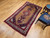 Mid-20th Century Vintage Persian Malayer area rug. Hand-knotted. Geometric elongated medallion pattern on camel hair field. Medallion in pink/cream and dark blue. Cream border with geometric designs in red, pink, green, yellow. Shabby chic wear. From Hama