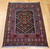 Mid-20th Century Vintage Afghan Baluch tribal area rug. Hand-knotted. Near square size. Geometric design in red and brown. Soumak kilim weaving incorporated in design.