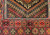 Mid-20th Century Vintage Afghan Baluch tribal area rug. Hand-knotted. Near square size. Geometric design in red and brown. Soumak kilim weaving incorporated in design.