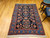 Vintage Persian Malayer rug with allover geometric pattern in navy, French blue, green, pink, and red – early 1900s hand-knotted rug with natural abrash and floral border.