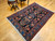 Vintage Persian Malayer rug with allover geometric pattern in navy, French blue, green, pink, and red – early 1900s hand-knotted rug with natural abrash and floral border.