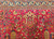Vintage Persian Kerman Lavar in "Tree of Life" pattern with floral design set in an ivory color field from the first half of the 20th century.  There are several beautiful designs that are incorporated in this rug including a row of cypress trees on the lower part of the rug.  Also the range of the colors in the design include green, gold, blue, and red.  The corner spandrels on the upper section of the design are in a bright red color with floral design.  The primary border is also in ivory color with flowers and tree designs throughout.
