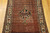 Antique Persian Malayer rug, Hamadan weaving, with paisley and medallion design on brick-red field and cream border, early 1900s.