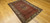 Antique Persian Malayer rug, Hamadan weaving, with paisley and medallion design on brick-red field and cream border, early 1900s.