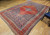 Late 19th Century Antique Persian Malayer room size rug. Hand-knotted. Terracotta red field with a large medallion and a smaller central navy blue medallion. Herati design in navy blue, baby blue, and red. Red major border with branches and flowers in navy blue, baby blue, and ivory.