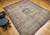 Late 19th Century Antique Persian Kerman Lavar area rug. Handwoven. Rare near-square size. Floral central medallion on ivory background. Scrolling vines and flowers in black and red throughout field. Five borders with floral designs in black, red, and cream. Weaver's signature in top border.