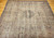 Late 19th Century Antique Persian Kerman Lavar area rug. Handwoven. Rare near-square size. Floral central medallion on ivory background. Scrolling vines and flowers in black and red throughout field. Five borders with floral designs in black, red, and cream. Weaver's signature in top border.