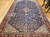 Late 19th-century Persian Qashqai tribal gallery rug in navy, ivory, and royal blue with paisley motifs and central medallion.