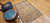 Vintage Moroccan camel hair rug with large tribal diamond motifs and earth-tone palette, circa mid-20th century.