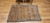 Vintage Moroccan camel hair rug with large tribal diamond motifs and earth-tone palette, circa mid-20th century.