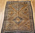 Vintage Moroccan camel hair rug with large tribal diamond motifs and earth-tone palette, circa mid-20th century.