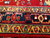 Vintage Persian Heriz runner with five geometric medallions in navy, ivory, and red on a brilliant red field. Dark blue border adds striking contrast. Handwoven and richly colored.