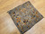 Antique 19th-century Caucasian Kazak bagface with geometric squares in blue, brown, and red. Small tribal rug for wall display or textile collection.