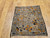 Antique 19th-century Caucasian Kazak bagface with geometric squares in blue, brown, and red. Small tribal rug for wall display or textile collection.