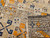 Antique 19th-century Caucasian Kazak bagface with geometric squares in blue, brown, and red. Small tribal rug for wall display or textile collection.
