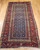 Late 19th Century Antique Kurdish gallery-size rug. Hand-woven. Paisley pattern. Blue background. Predominantly rust-colored border. Ideal for a hallway or as a wide runner.