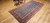 Late 19th Century Antique Kurdish gallery-size rug. Hand-woven. Paisley pattern. Blue background. Predominantly rust-colored border. Ideal for a hallway or as a wide runner.