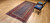 Late 19th Century Antique Kurdish gallery-size rug. Hand-woven. Paisley pattern. Blue background. Predominantly rust-colored border. Ideal for a hallway or as a wide runner.